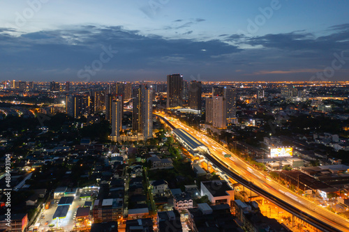 Aerial view of highway street road at Bangkok Downtown Skyline, Thailand. Financial district and business centers in smart urban city in Asia. Skyscraper and high-rise buildings at night.