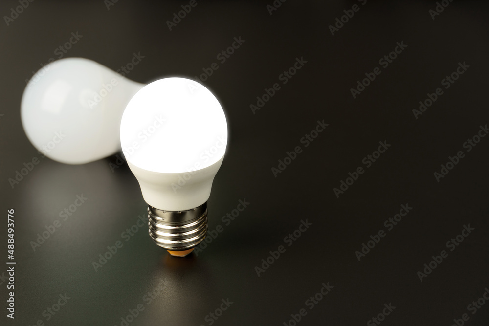 two energy-saving LED lamps, on a black background. two energy-saving LED lamps, on a black background.