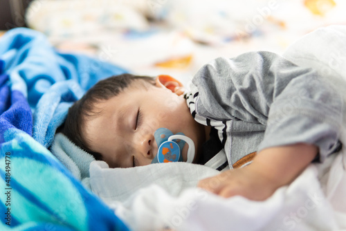 Close-up Adorable cute toddler or baby sleeping on bed at night sweet dream in bedroom-Copy space