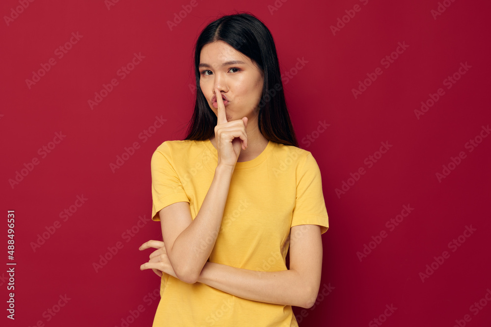 woman gestures with his hands in a yellow t-shirt casual wear Lifestyle unaltered woman gestures with his hands in a yellow t-shirt casual wear Lifestyle unaltered