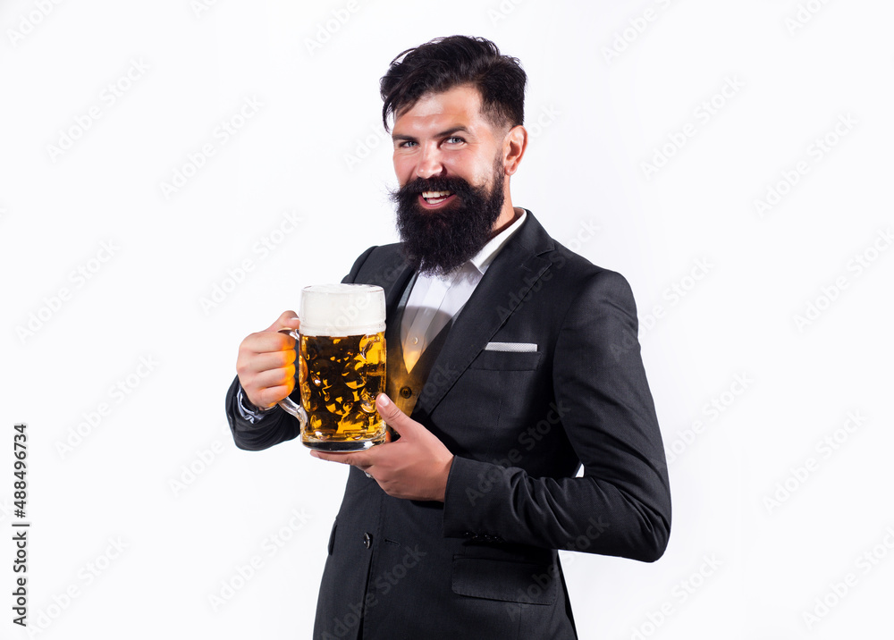 Hipster with beard and mustache in suit drinks beer after working day. Germany Bavaria. Beer time. Barman holding a pint cup of beer. Hipster with beard and mustache in suit drinks beer after working day. Germany Bavaria. Beer time. Barman holding a pint cup of beer.