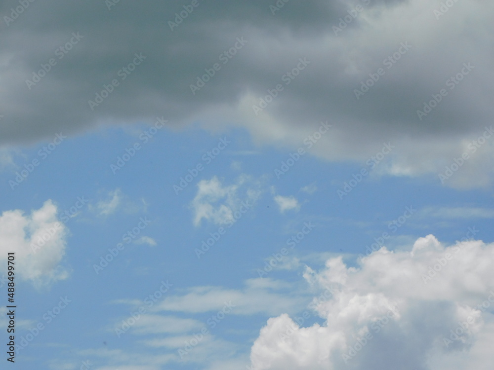 Spectacular photo of various cloud formations. large white and grey storm cloud formations, thin streaky white clouds in a blue sky on a sunny day. Spectacular photo of various cloud formations. large white and grey storm cloud formations, thin streaky white clouds in a blue sky on a sunny day.