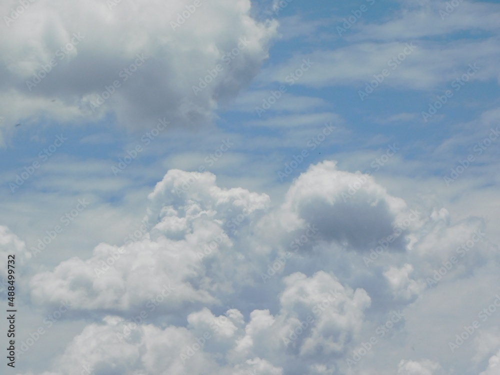 Spectacular photo of various cloud formations. large white and grey storm cloud formations, thin streaky white clouds in a blue sky on a sunny day. Spectacular photo of various cloud formations. large white and grey storm cloud formations, thin streaky white clouds in a blue sky on a sunny day.