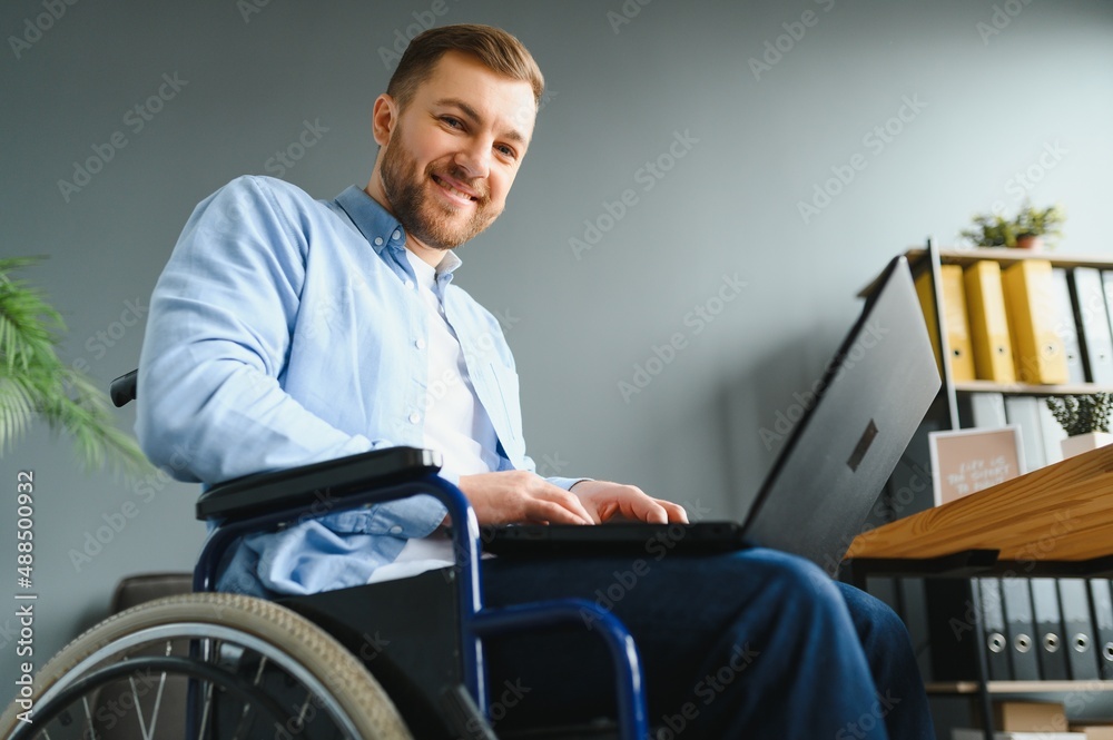 Man in wheelchair at home or in office. Man in wheelchair at home or in office.