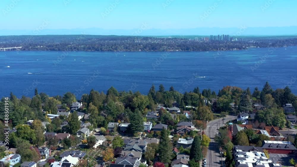 Drone flying over the Madrona Neighborhood with views of Lake Washington, snow covered Cascade Mountains, Bellevue and the neighborhood Drone flying over the Madrona Neighborhood with views of Lake Washington, snow covered Cascade Mountains, Bellevue and the neighborhood