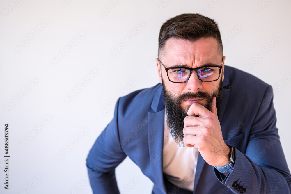 Portrait of businessman who is thoughtful and worried. Copy space on image for your text or advert.