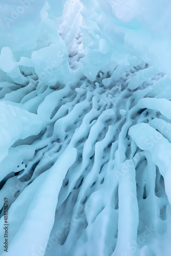 Ice and snow patterns and icicles on rocks in the cave - The rock on the frozen lake Baikal is covered with a thick layer - Baikal lake