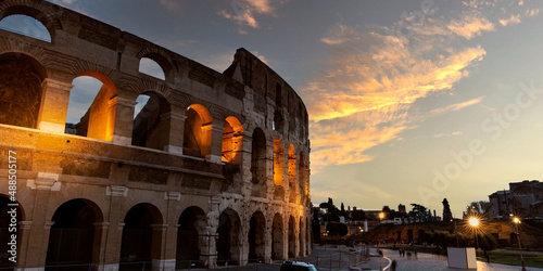 Panoramic view with  the famous of the Coliseum or Flavian Amphitheatre (Amphitheatrum Flavium or Colosseo),  sunset sky scene  at Rome, Italy. photo