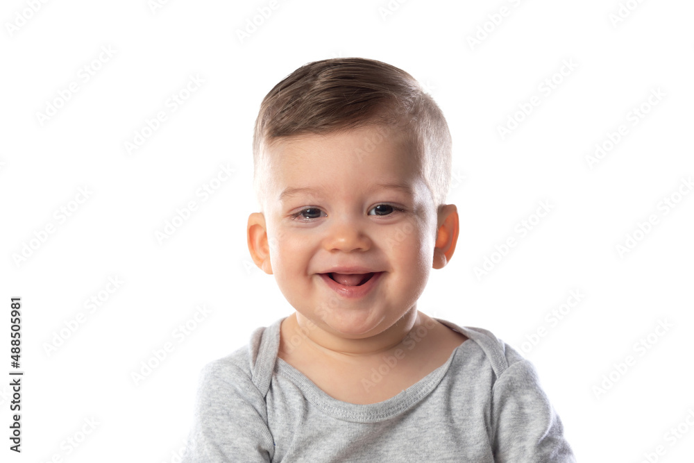 Little smiling baby in bodysuit sitting barefoot on the floor Little smiling baby in bodysuit sitting barefoot on the floor