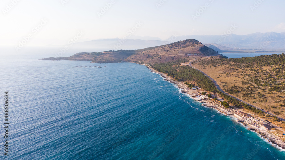 Typical Albanian landscape on the Adriatic shore with mountains. Sunny morning in Albania, Europe. Traveling concept background.