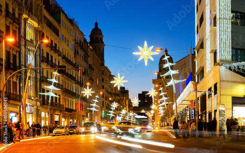 Barcelona in evening during christmas time with decorations and turned on city lights.