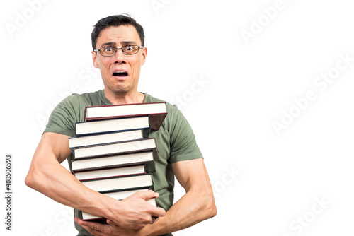 Scared male student with books looking at camera