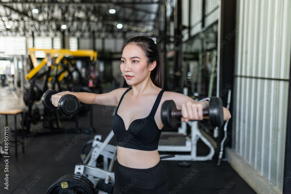 Fototapeta premium exercise concept The exercising starter giving a focus on working on dumbbells by doing core stabilization with both arms