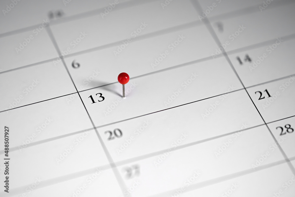 13th marked in the calendar with a red pin 13th marked in the calendar with a red pin