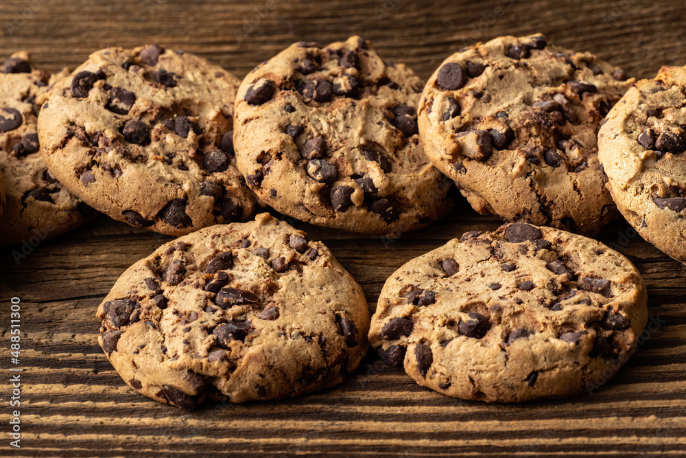 Chocolate chip cookies on wooden table.