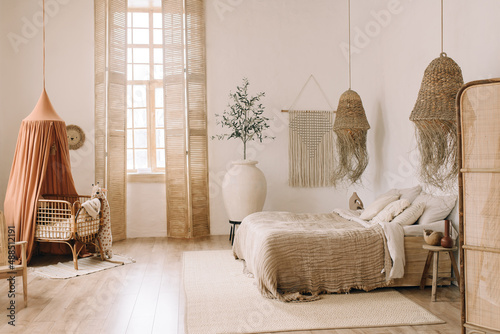 Bright bedroom boho room with décor and cot