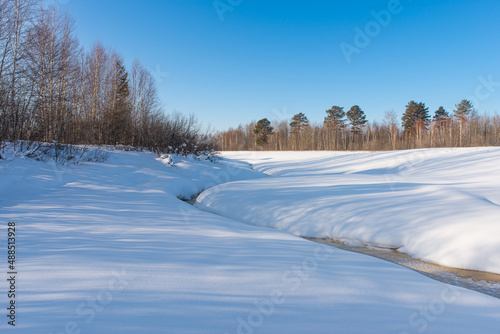 Wallpaper Mural Frozen small river. Winter landscape against the blue sky Torontodigital.ca