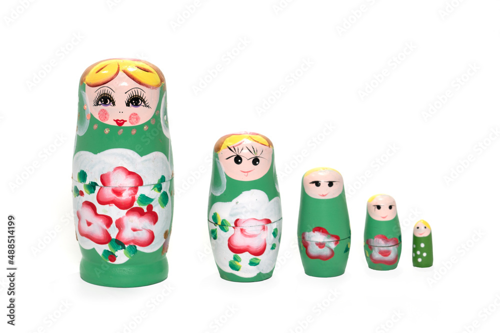 Green colored nesting dolls on a white background. Russian national souvenir.