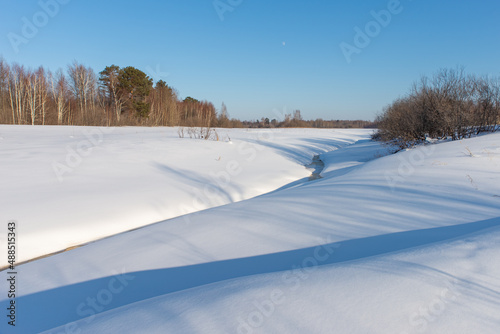 Wallpaper Mural Frozen small river. Winter landscape against the blue sky Torontodigital.ca