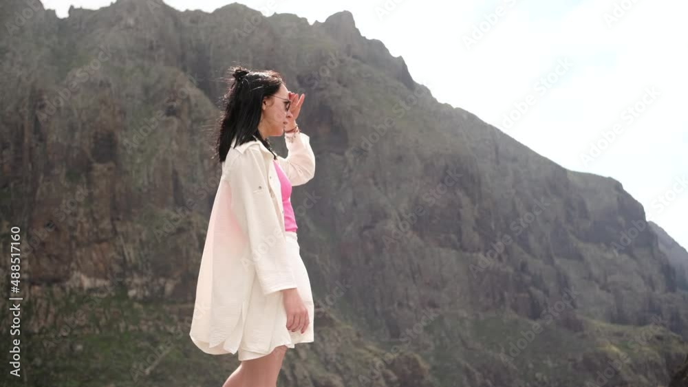 Portrait of beautiful young woman in sunglasses overlooking glorious mountains landscape Portrait of beautiful young woman in sunglasses overlooking glorious mountains landscape