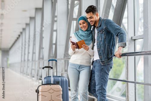 Portrait Of Happy Islamic Travellers Couple Standing At Airport