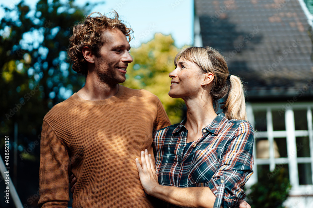 Smiling man and woman looking at each other Smiling man and woman looking at each other