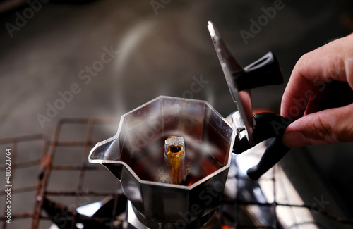 Coffee beans in Moka pot and smoke.Brewing black moka coffee using moka coffee maker photo