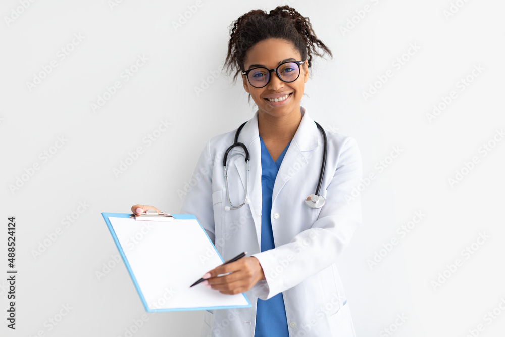 Portrait of black doctor looking at camera showing clipboard Portrait of black doctor looking at camera showing clipboard