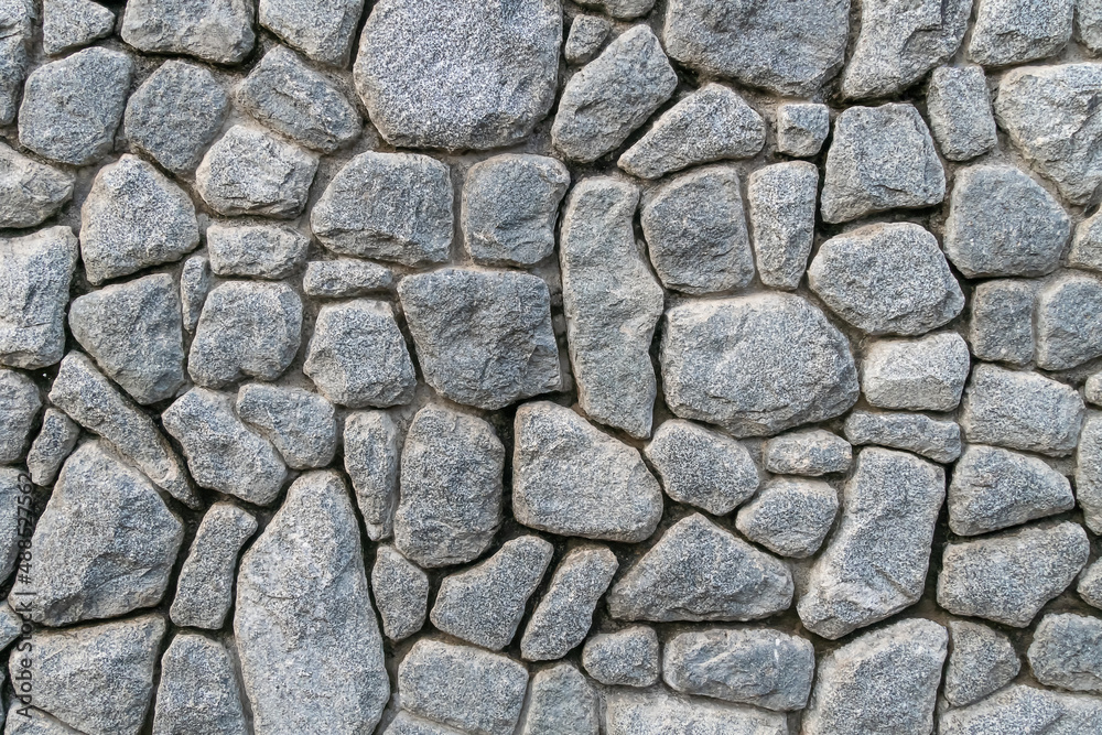 Texture of a gray stone wall. Texture background of the stone wall of the old castle. Stone wall as a background or texture. Texture of a gray stone wall. Texture background of the stone wall of the old castle. Stone wall as a background or texture.