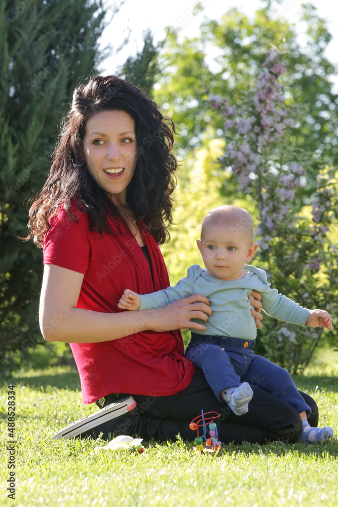 Young mother enjoying a idyllic summer day outdoor with her baby boy Young mother enjoying a idyllic summer day outdoor with her baby boy
