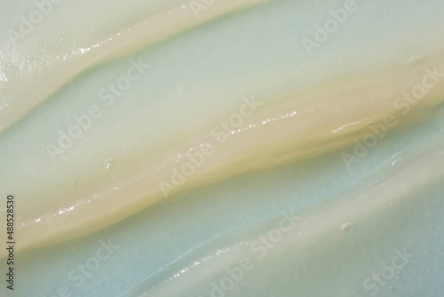 Hydrophilic oil based cleanser cleansing balm swatch. Gentle makeup removing cream on the blue background.