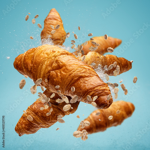 Freshly baked croissant flying in air