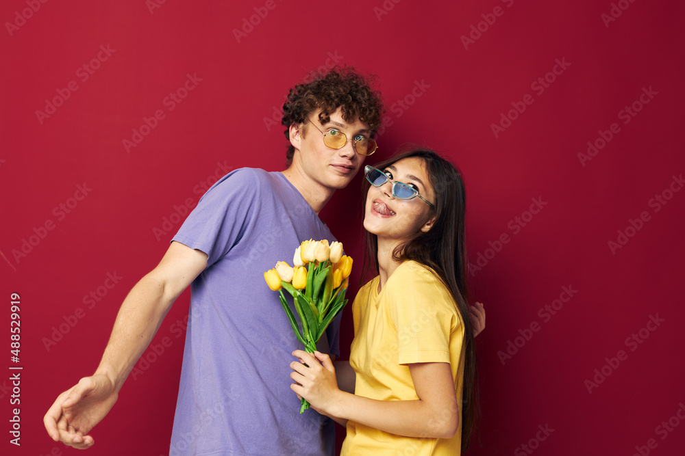 young boy and girl a bouquet of yellow flowers based friendship red background unaltered