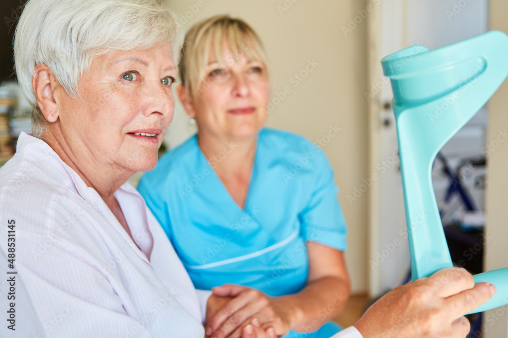 Elderly woman with crutches after a stroke and caregiver