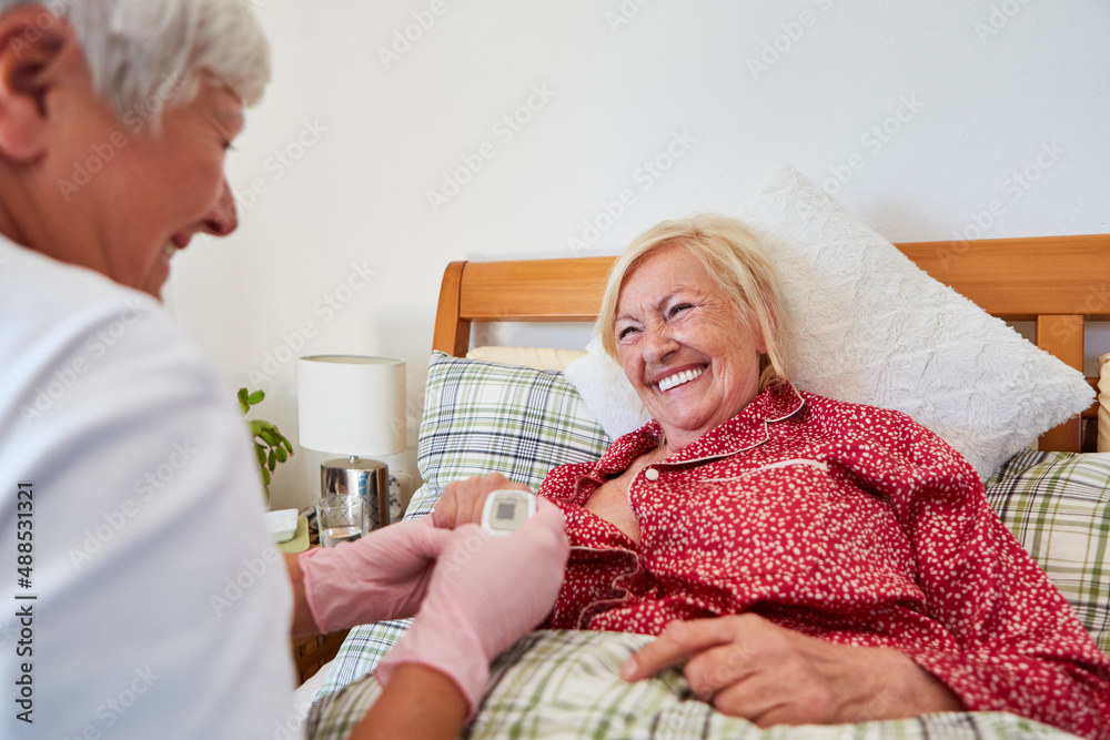 A doctor checks the heart rate of a senior citizen A doctor checks the heart rate of a senior citizen