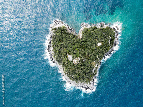 Aerial view of Bergeggi island, heart island from above, in Liguria, north Italy. Drone photography of the Ligurian coast, province of Savona with Spotorno and the island of Bergeggi. © AerialDronePics