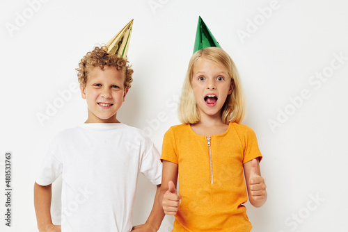 cheerful children with caps on his head holiday entertainment isolated background unaltered