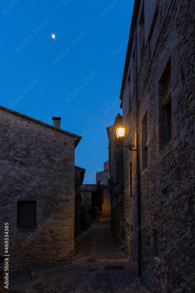 typical cobbled street of the town of pals in the spanish costa brava at night