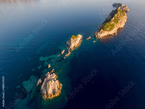 Aerial drone view of small island next to arillas beach in corfu greece