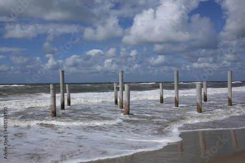 Wooden poles at the Dutch coast standing in the water due to high tide  © RMMPPhotography