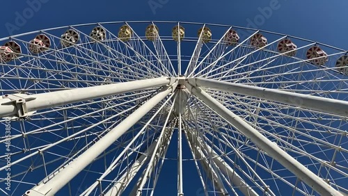 Ferris wheel in an amusement park, good weather, blue sky
