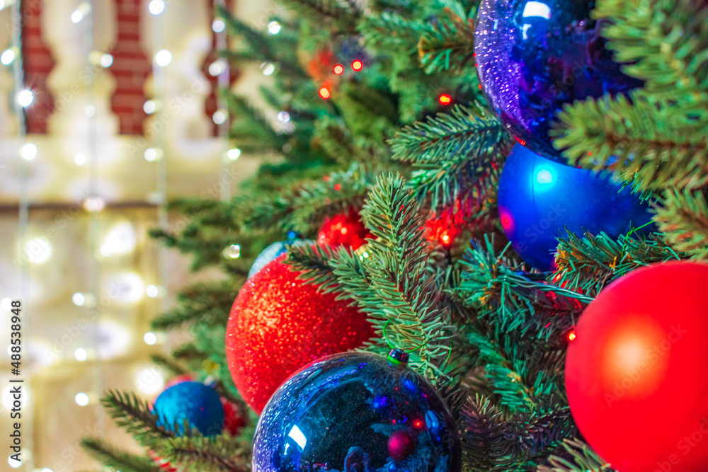 Close up of balls on christmas tree. Bokeh garlands in the background. New Year concept. Close up of balls on christmas tree. Bokeh garlands in the background. New Year concept.
