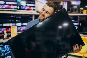 Man buying television at store