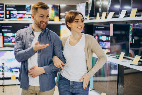 Couple choosing television at store