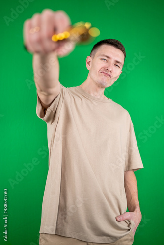 a young man with a gun on a green background