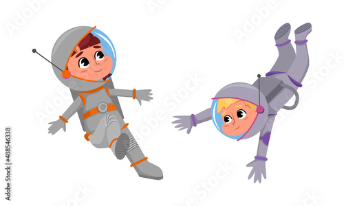 Cute boy and girl astronauts in space suits floating in outer space cartoon vector illustration