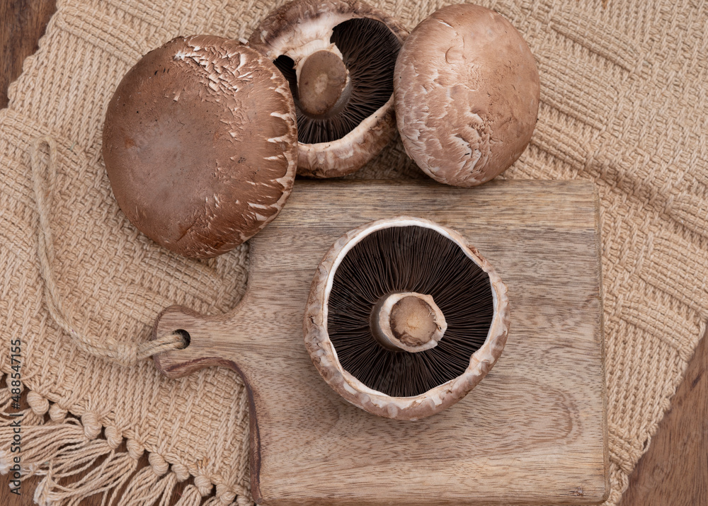 Tasty vegetarian food, large brown champignons Agaricus bisporus portobello mushrooms Tasty vegetarian food, large brown champignons Agaricus bisporus portobello mushrooms