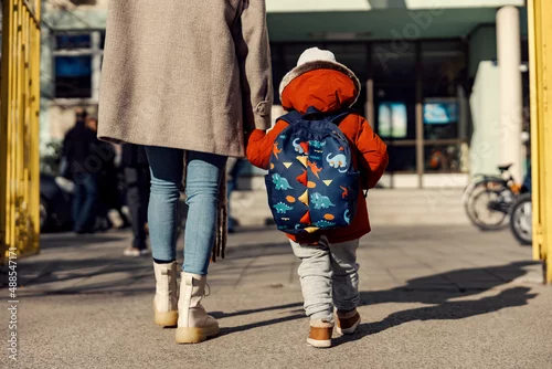 Obraz A mother entering the kindergarten yard with her preschooler boy.