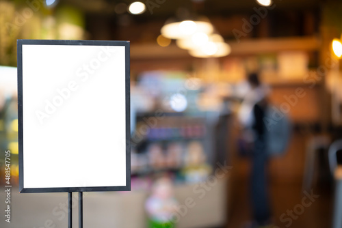 Wallpaper Mural mockup white poster with black frame stand in front of blur restaurant cafe background Torontodigital.ca