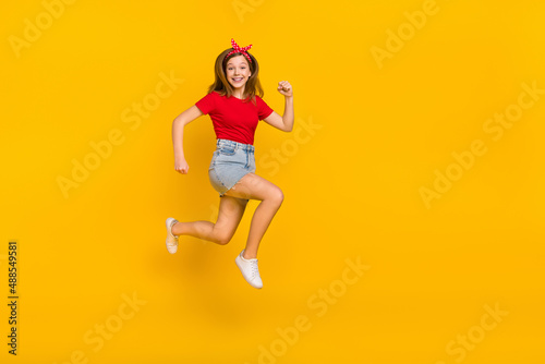 Fototapeta Naklejka Na Ścianę i Meble -  Full size photo of impressed teen girl run wear t-shirt hairband skirt footwear isolated on yellow background